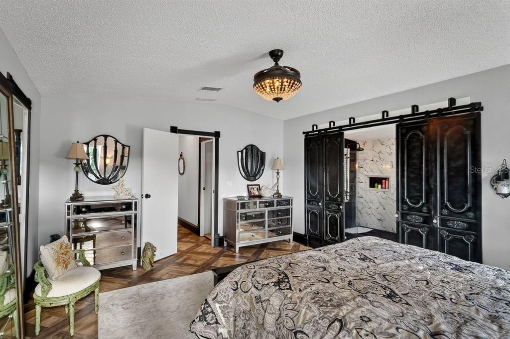 747 Navigators Way Edgewater, FL 32141 - Photo 43 of 73 a bedroom with a bed and a flat tv screen in it