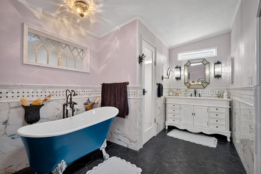 747 Navigators Way Edgewater, FL 32141 - Photo 45 of 73 a bathroom with a double vanity sink mirror and bathtub