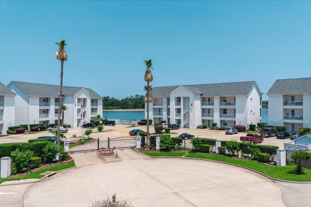 a front view of a building with cars parked