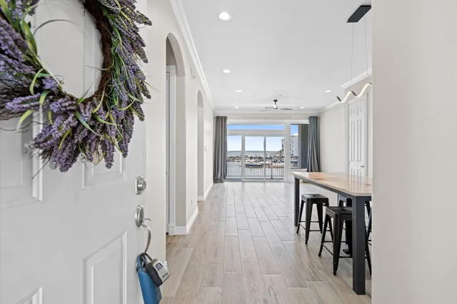 a view of entryway and hall with wooden floor