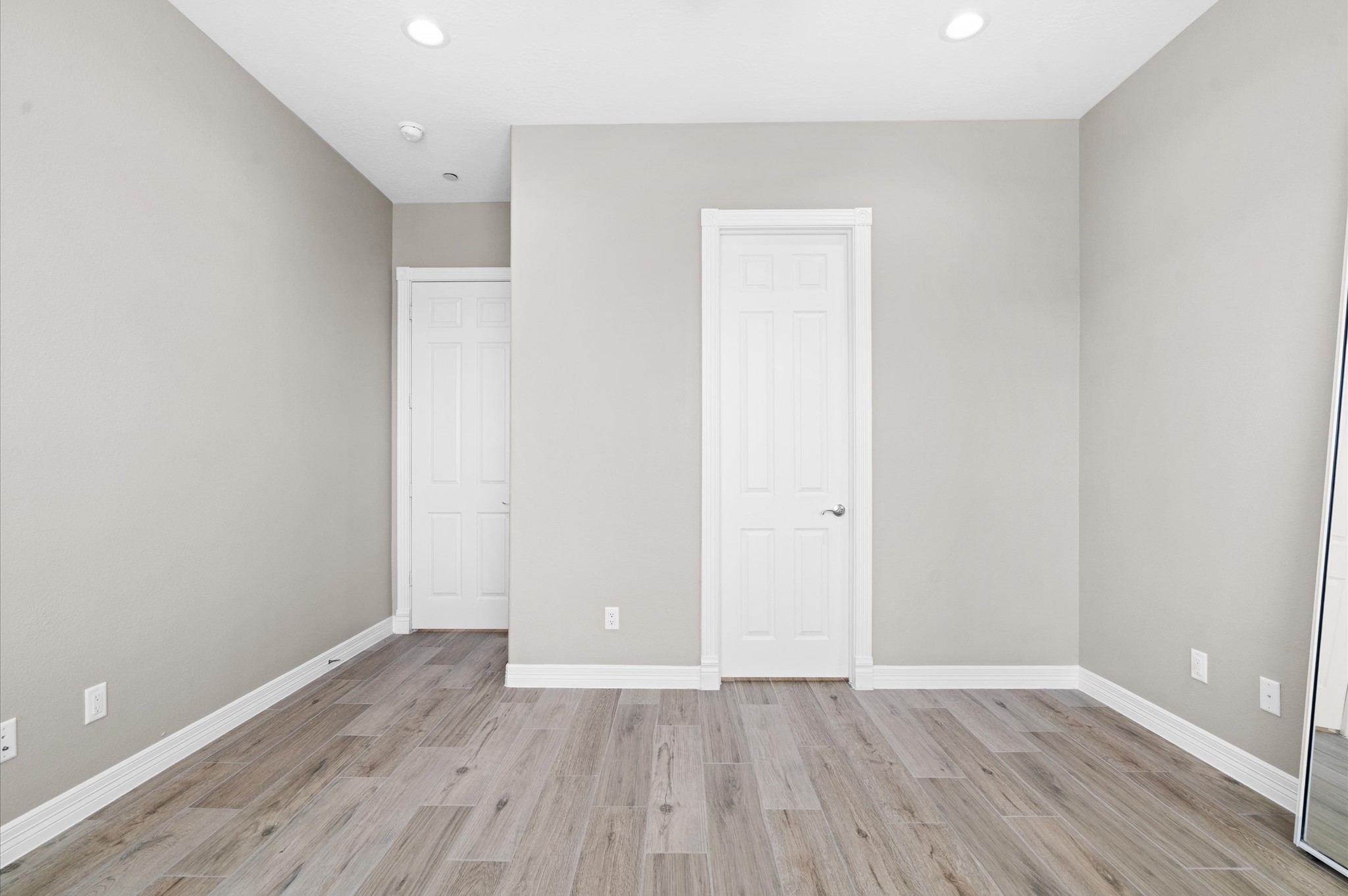 168 Lake Point Boulevard, Unit C202 Conroe, TX 77356 - Photo 6 of 14 a view of an empty room with wooden floor