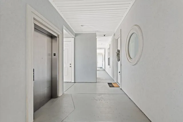 a view of a hallway with windows