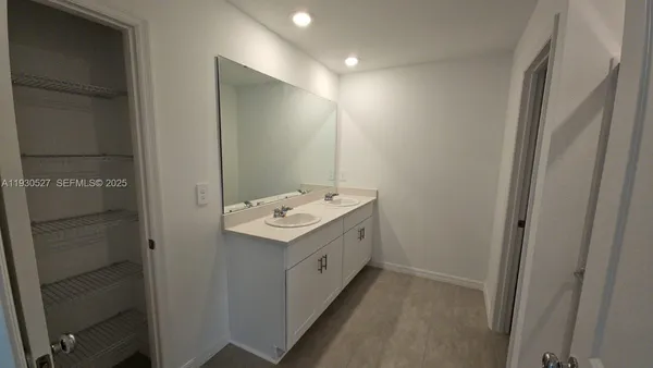 a bathroom with a double vanity sink and toilet