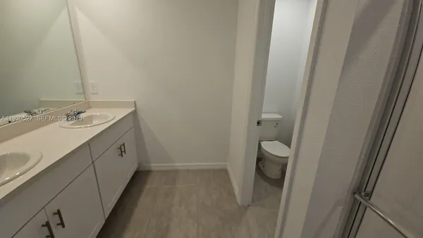 a bathroom with a glass shower door