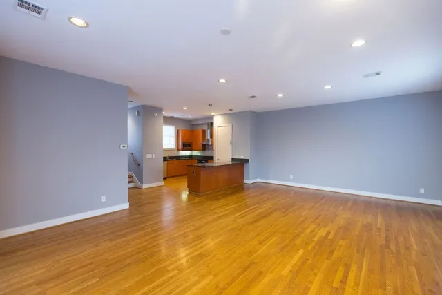 a view of a kitchen with a large counter top and living room