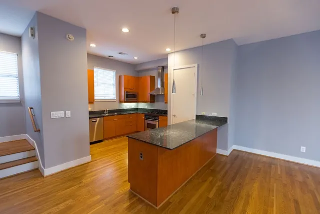 a kitchen with granite countertop a stove and a sink