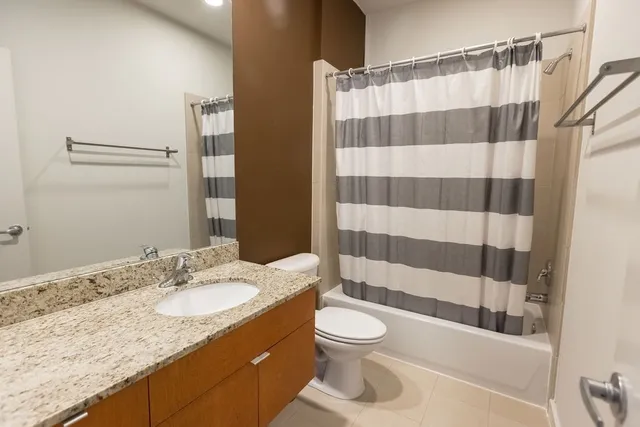 a bathroom with a sink a toilet a shower and a mirror