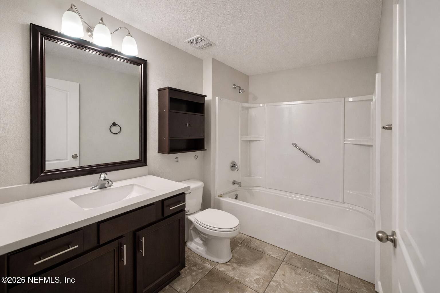 5937 Round Table Road Jacksonville, FL 32254 - Photo 8 of 10 a bathroom with a sink a toilet and shower