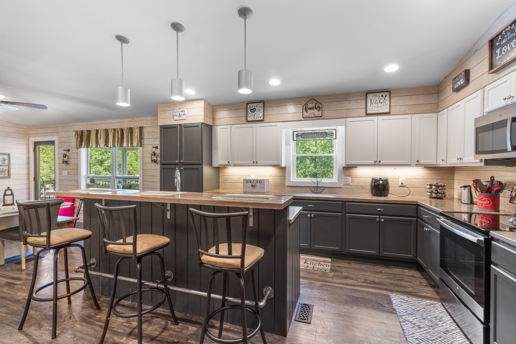 724 Plunders Creek Road Dickson, TN 37055 - Photo 5 of 29 a kitchen with kitchen island granite countertop a stove a sink a oven a dining table and chairs with wooden floor