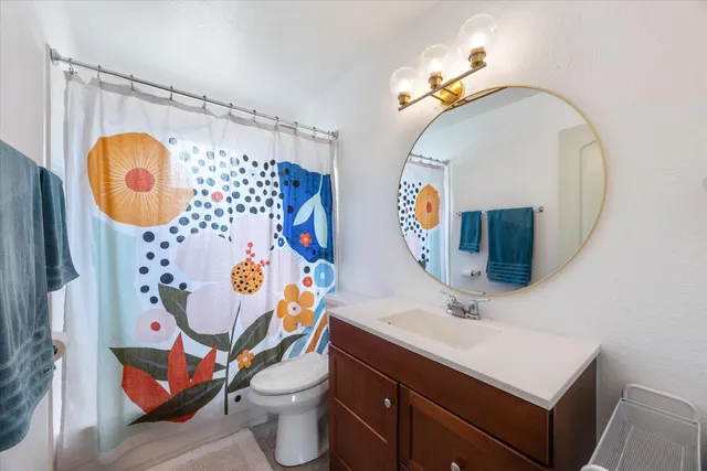 a bathroom with a sink mirror and vanity