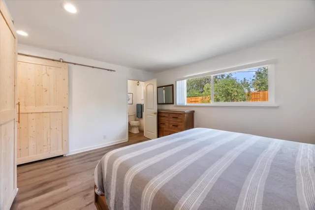 a bedroom with a large bed and a window