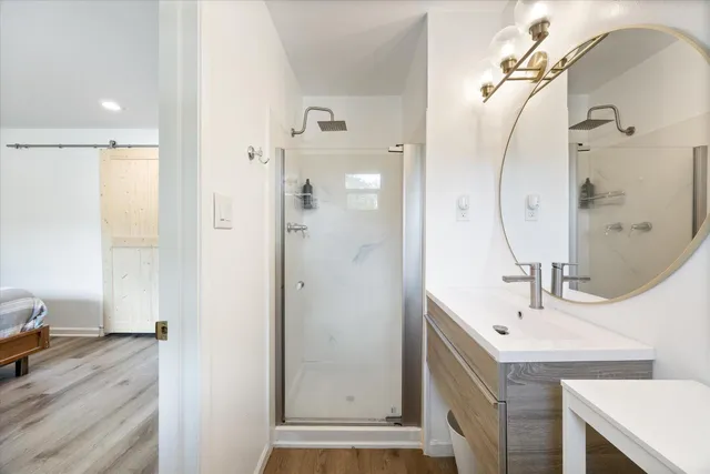 a bathroom with a sink vanity and a mirror