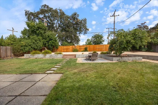 a view of a chairs and table in backyard