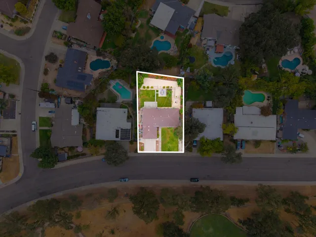 an aerial view of a house with garden space and street view