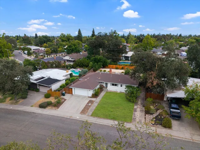 a white house that has a tree in front of it