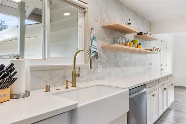 a kitchen with a sink a stove and cabinets