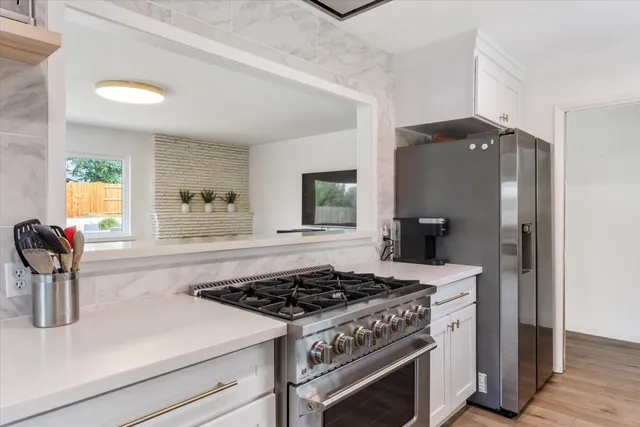 a kitchen with a stove and a refrigerator