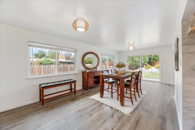 a dining room with furniture and a large window
