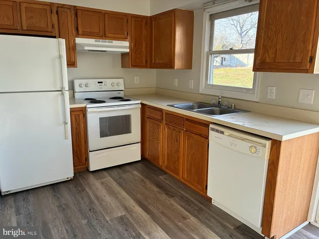 a kitchen with a white cabinets and white appliances