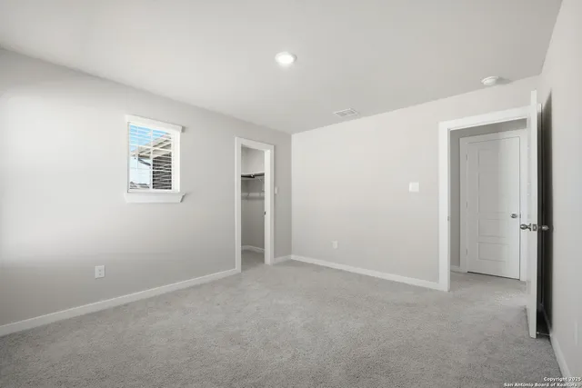 an empty room with windows and closet