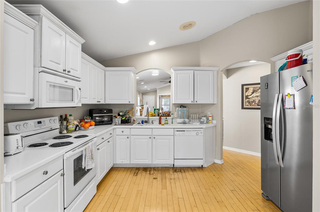 12113 Deertrack Loop Spring Hill, FL 34610 - Photo 11 of 31 a kitchen with stainless steel appliances a refrigerator sink and cabinets