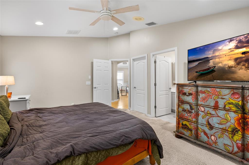 12113 Deertrack Loop Spring Hill, FL 34610 - Photo 16 of 31 a bedroom with a bed and a flat screen tv