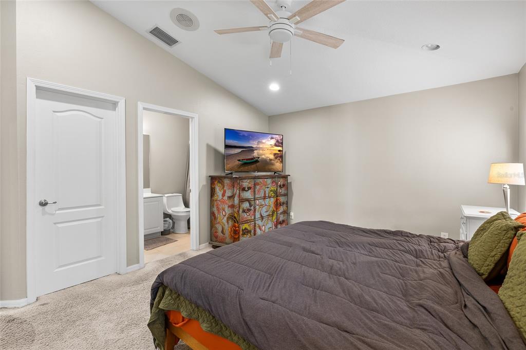 12113 Deertrack Loop Spring Hill, FL 34610 - Photo 17 of 31 a bedroom with a bed and a table