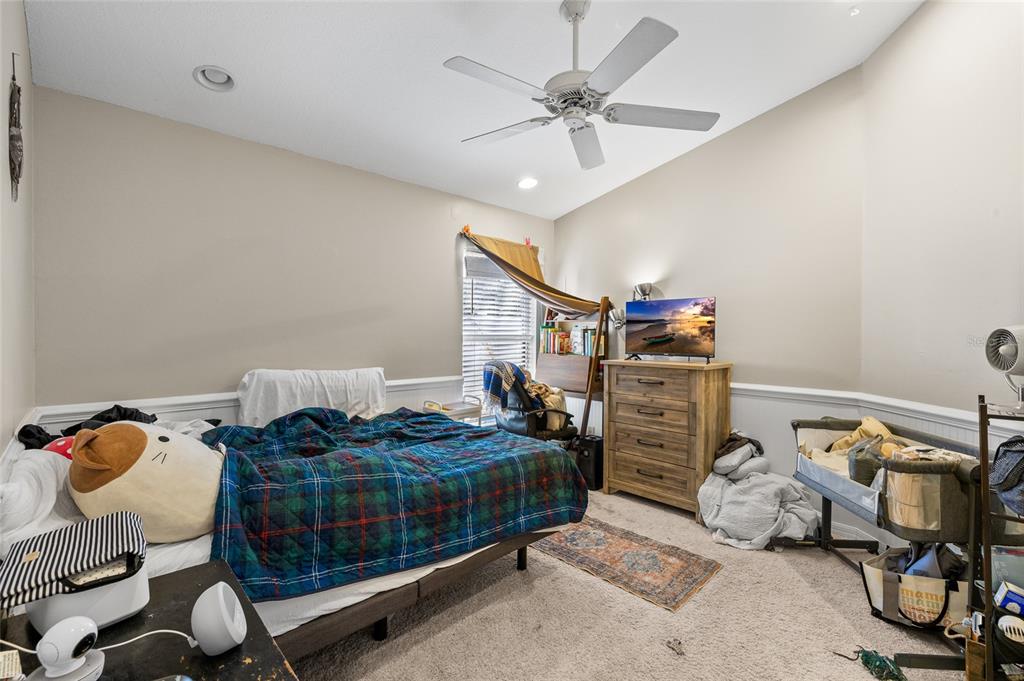 12113 Deertrack Loop Spring Hill, FL 34610 - Photo 19 of 31 a bedroom with a bed and cabinets