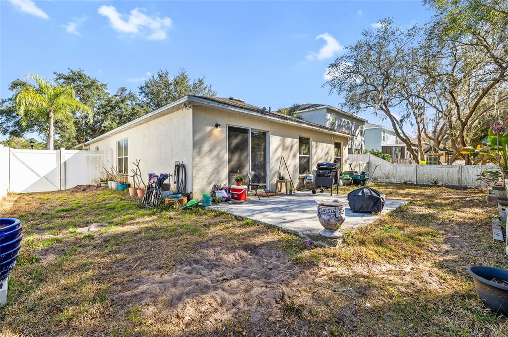 12113 Deertrack Loop Spring Hill, FL 34610 - Photo 23 of 31 a view of a house with backyard and a tree