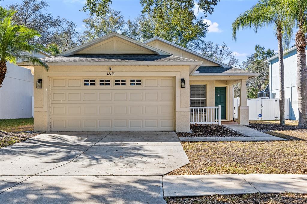 12113 Deertrack Loop Spring Hill, FL 34610 - Photo 29 of 31 a front view of a house with garden