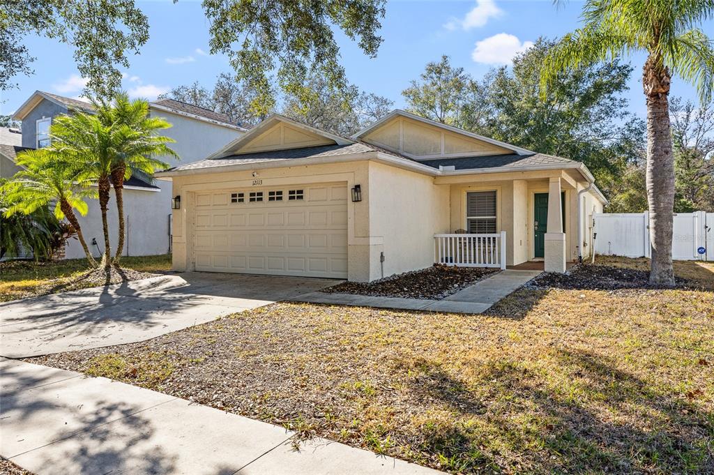 12113 Deertrack Loop Spring Hill, FL 34610 - Photo 5 of 31 a front view of a house with a yard and garage