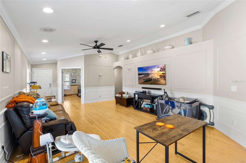 12113 Deertrack Loop Spring Hill, FL 34610 - Photo 8 of 31 a living room with furniture and a flat screen tv