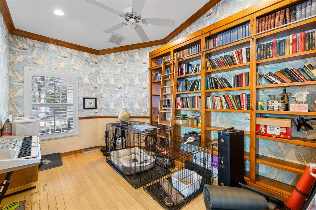 12113 Deertrack Loop Spring Hill, FL 34610 - Photo 10 of 31 a living room with furniture and a book shelf