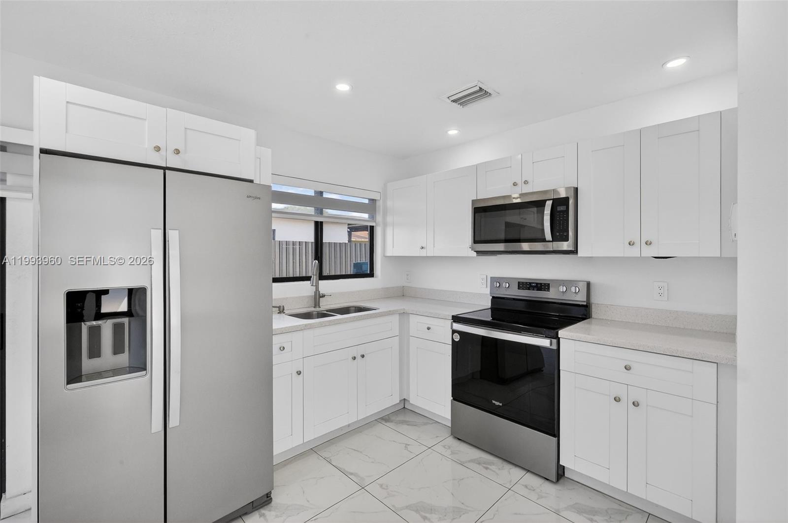 2492 Southwest 44th Street, Unit 2492 Miami, FL 33185 - Photo 1 of 34 a kitchen with stainless steel appliances a refrigerator sink and microwave