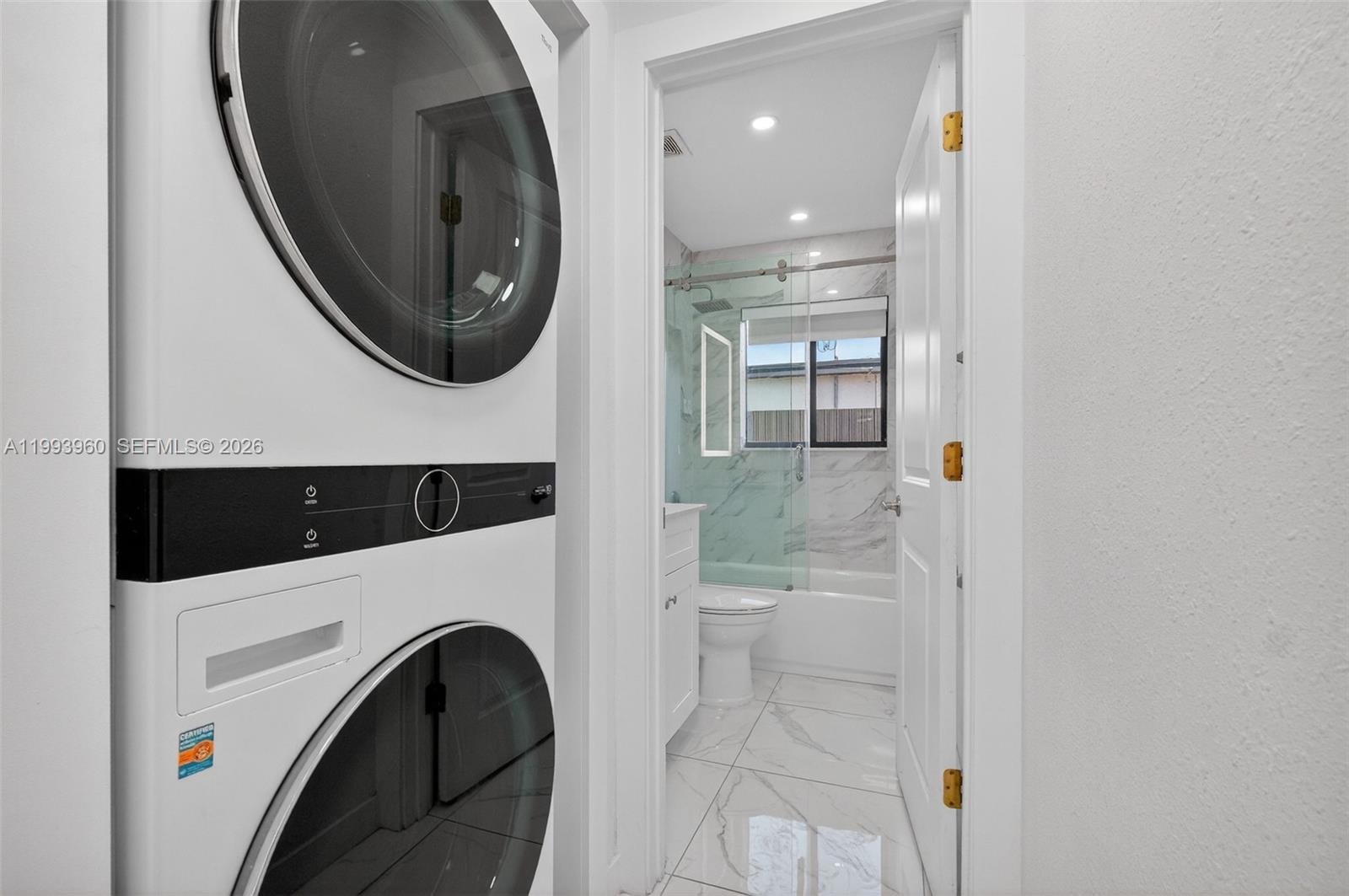 2492 Southwest 44th Street, Unit 2492 Miami, FL 33185 - Photo 18 of 34 a view of a hallway with washer and dryer