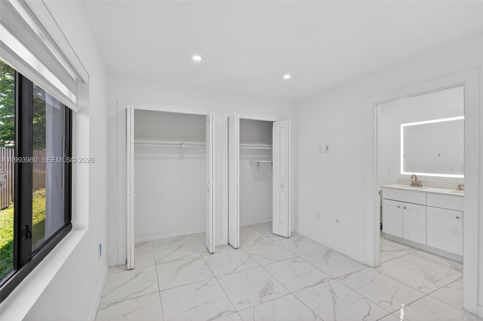 2492 Southwest 44th Street, Unit 2492 Miami, FL 33185 - Photo 22 of 34 a view of an empty room with window and cabinet