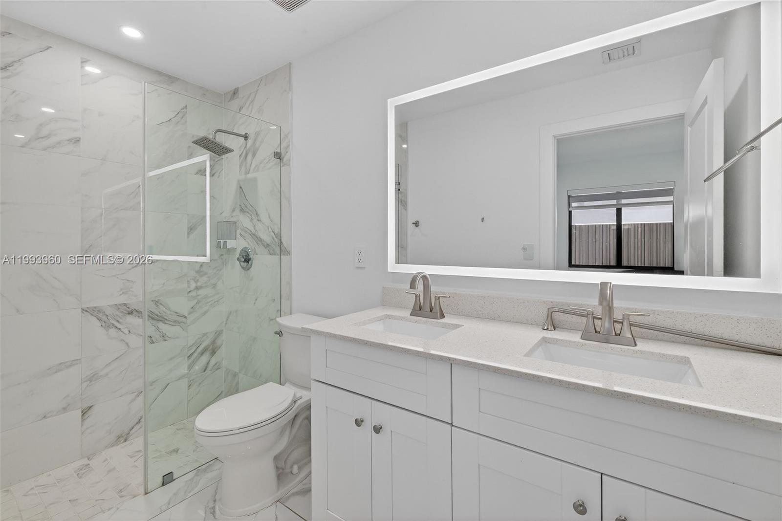 2492 Southwest 44th Street, Unit 2492 Miami, FL 33185 - Photo 24 of 34 a bathroom with a sink a toilet and shower