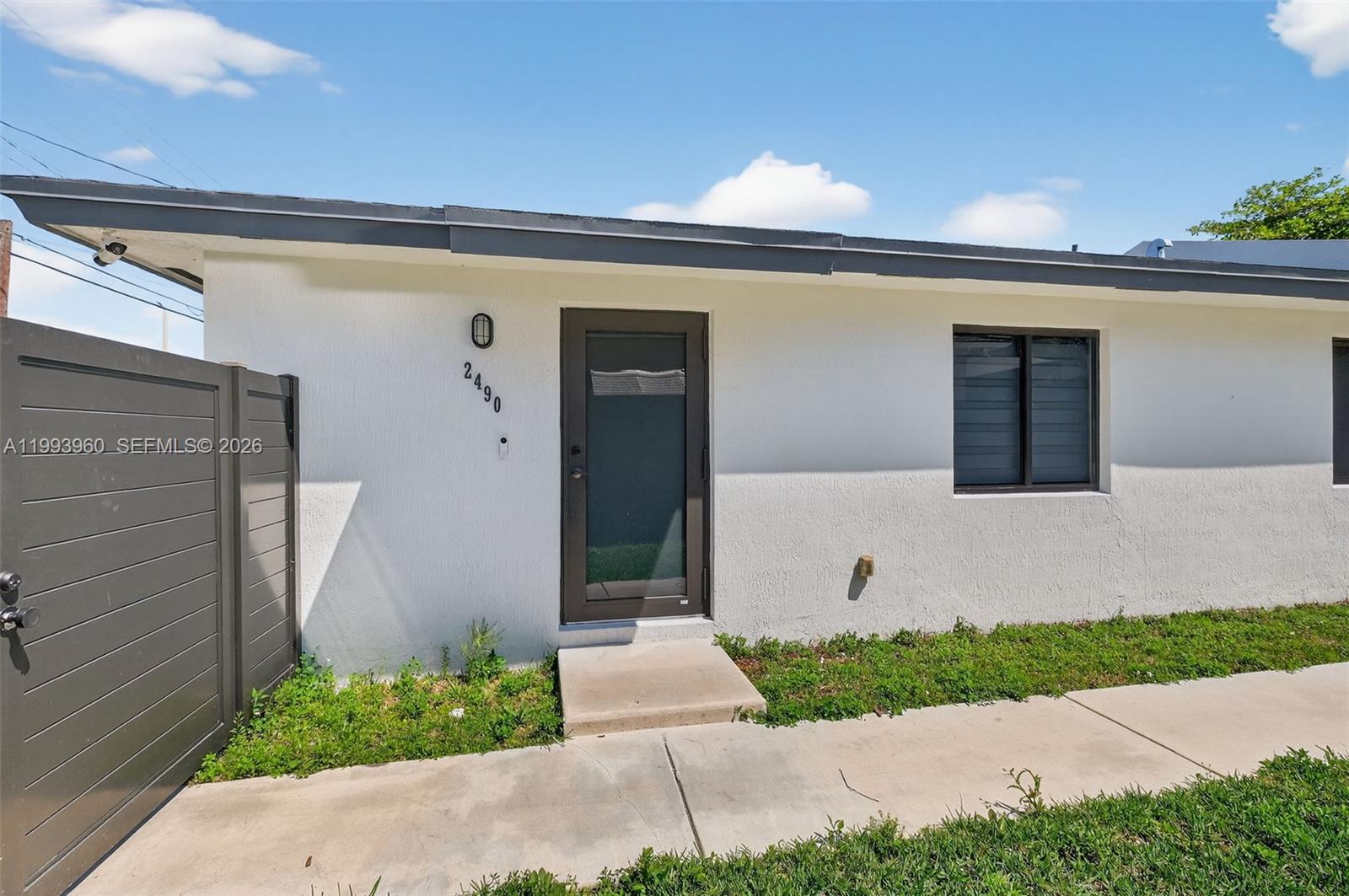 2492 Southwest 44th Street, Unit 2492 Miami, FL 33185 - Photo 3 of 34 a front view of a house with a yard and garage