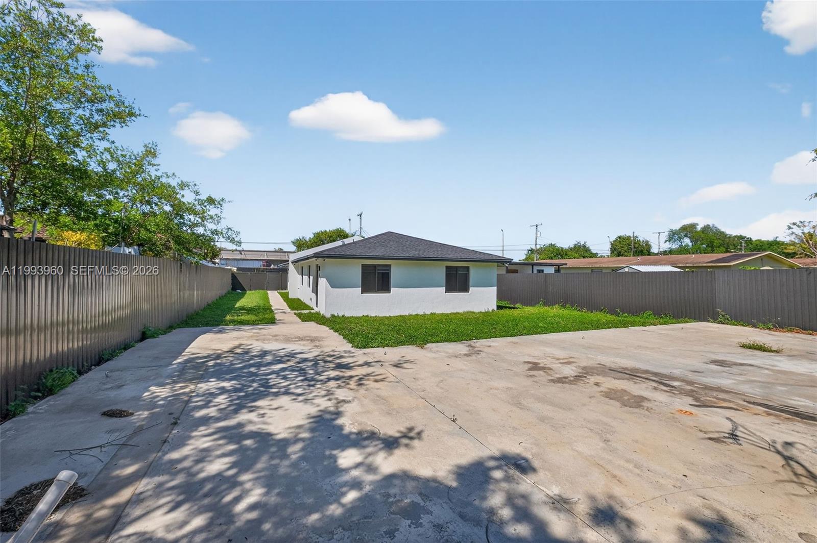 2492 Southwest 44th Street, Unit 2492 Miami, FL 33185 - Photo 32 of 34 a view of a brick house with a yard