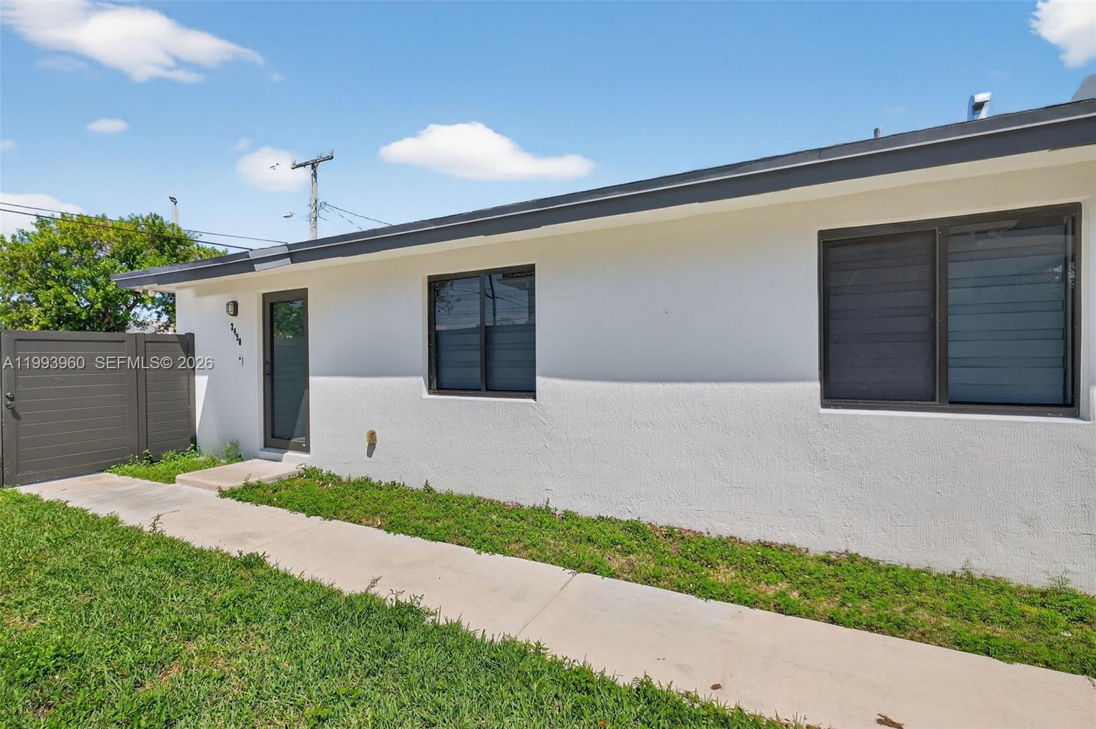 2492 Southwest 44th Street, Unit 2492 Miami, FL 33185 - Photo 5 of 34 a front view of a house with a yard