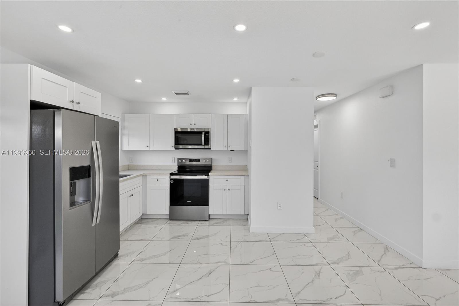 2492 Southwest 44th Street, Unit 2492 Miami, FL 33185 - Photo 10 of 34 a kitchen with stainless steel appliances a refrigerator sink and stove