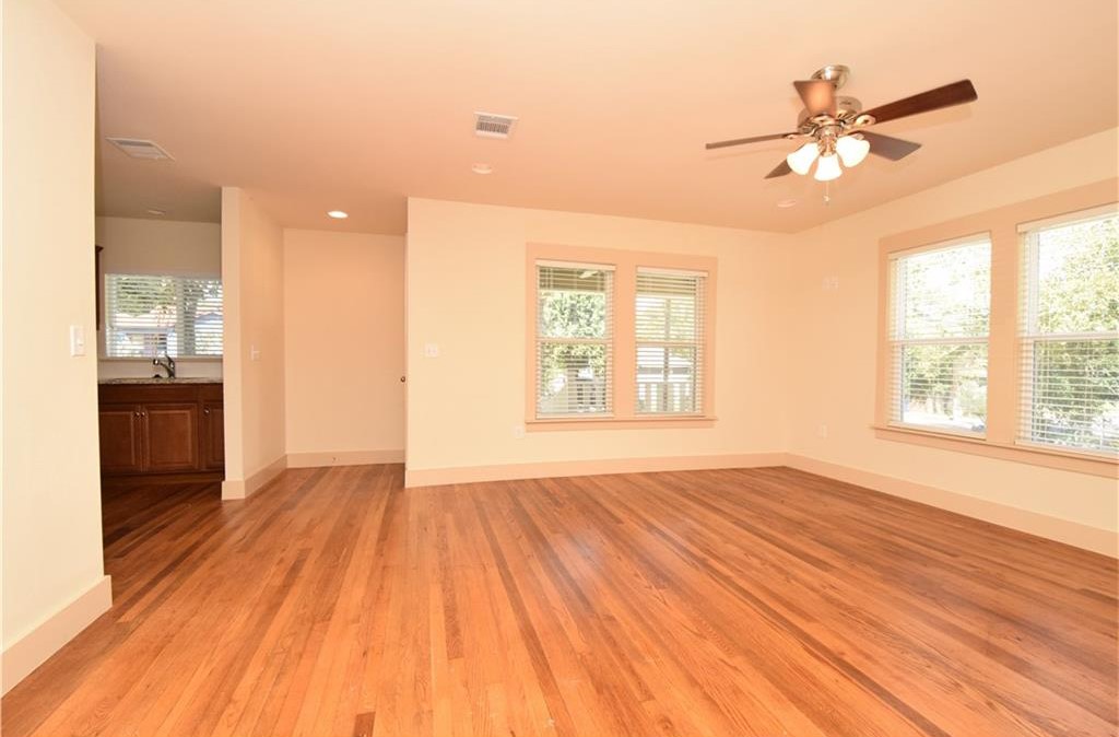 2817 East 22nd Street Austin, TX 78722 - Photo 15 of 18 a view of an empty room with wooden floor and a window