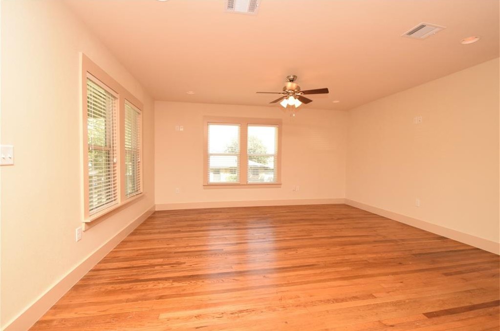 2817 East 22nd Street Austin, TX 78722 - Photo 16 of 18 a view of an empty room with a window and wooden floor