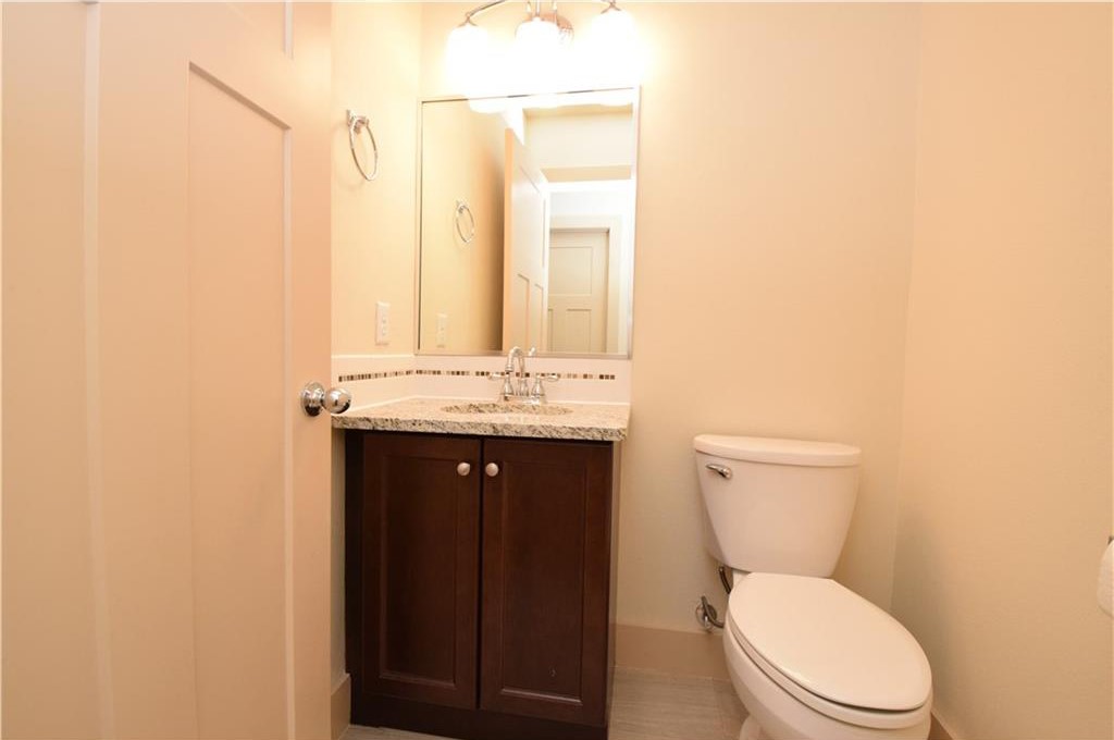 2817 East 22nd Street Austin, TX 78722 - Photo 18 of 18 a bathroom with a toilet a sink and mirror