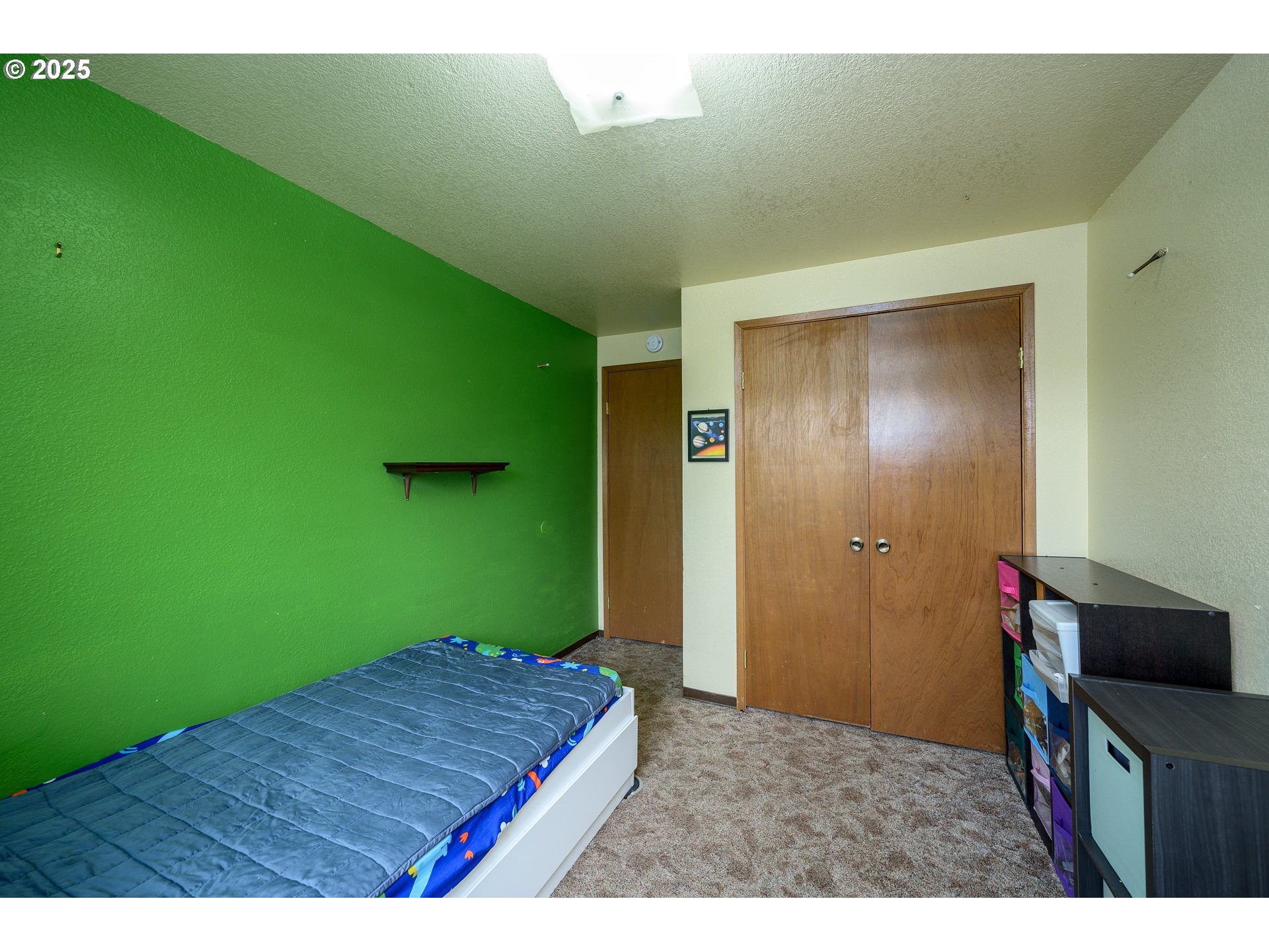 714 South Meridian Street Newberg, OR 97132 - Photo 19 of 35 a bedroom with a bed and a bookshelf