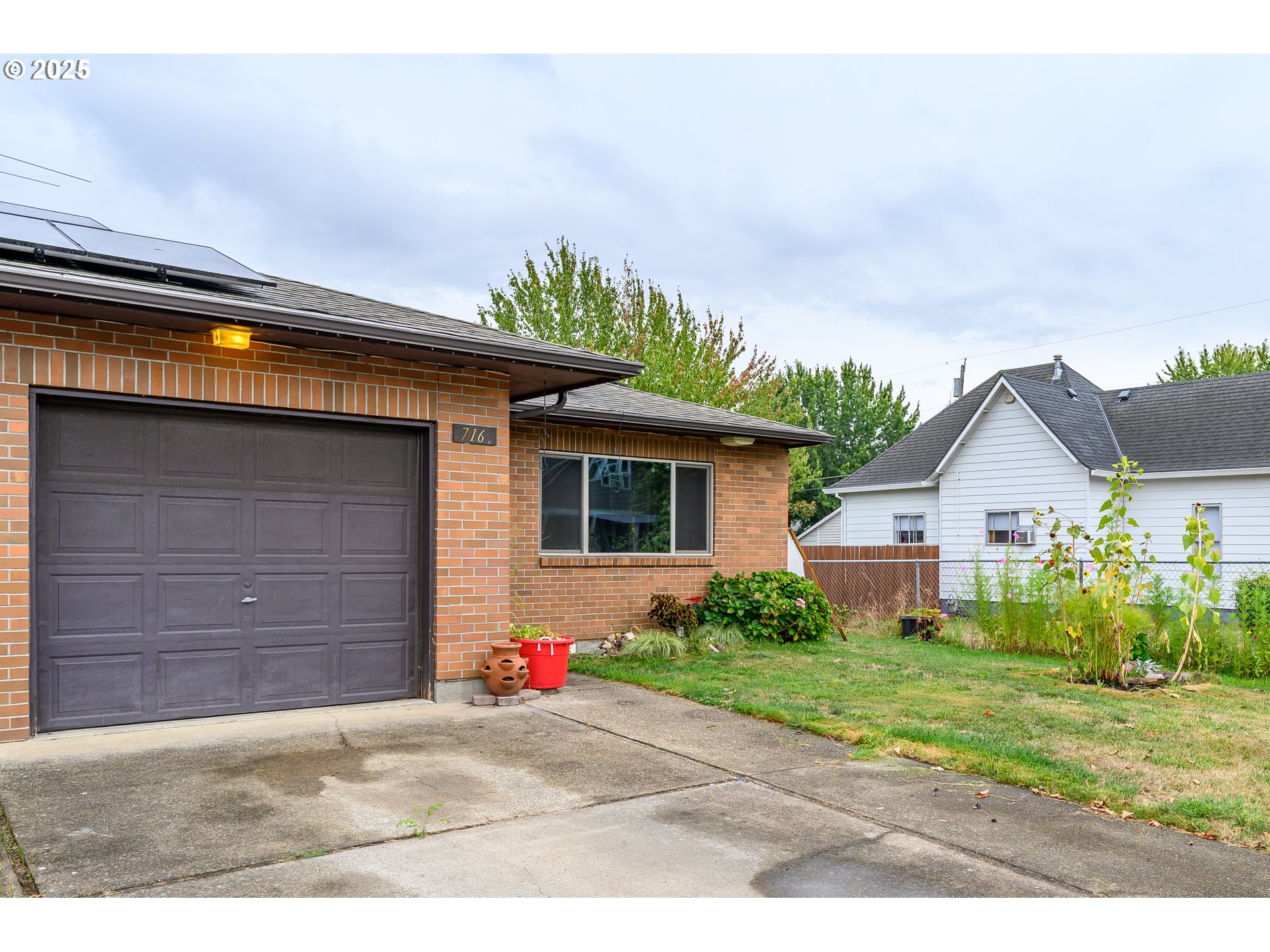 714 South Meridian Street Newberg, OR 97132 - Photo 30 of 35 a front view of a house with a yard and garage