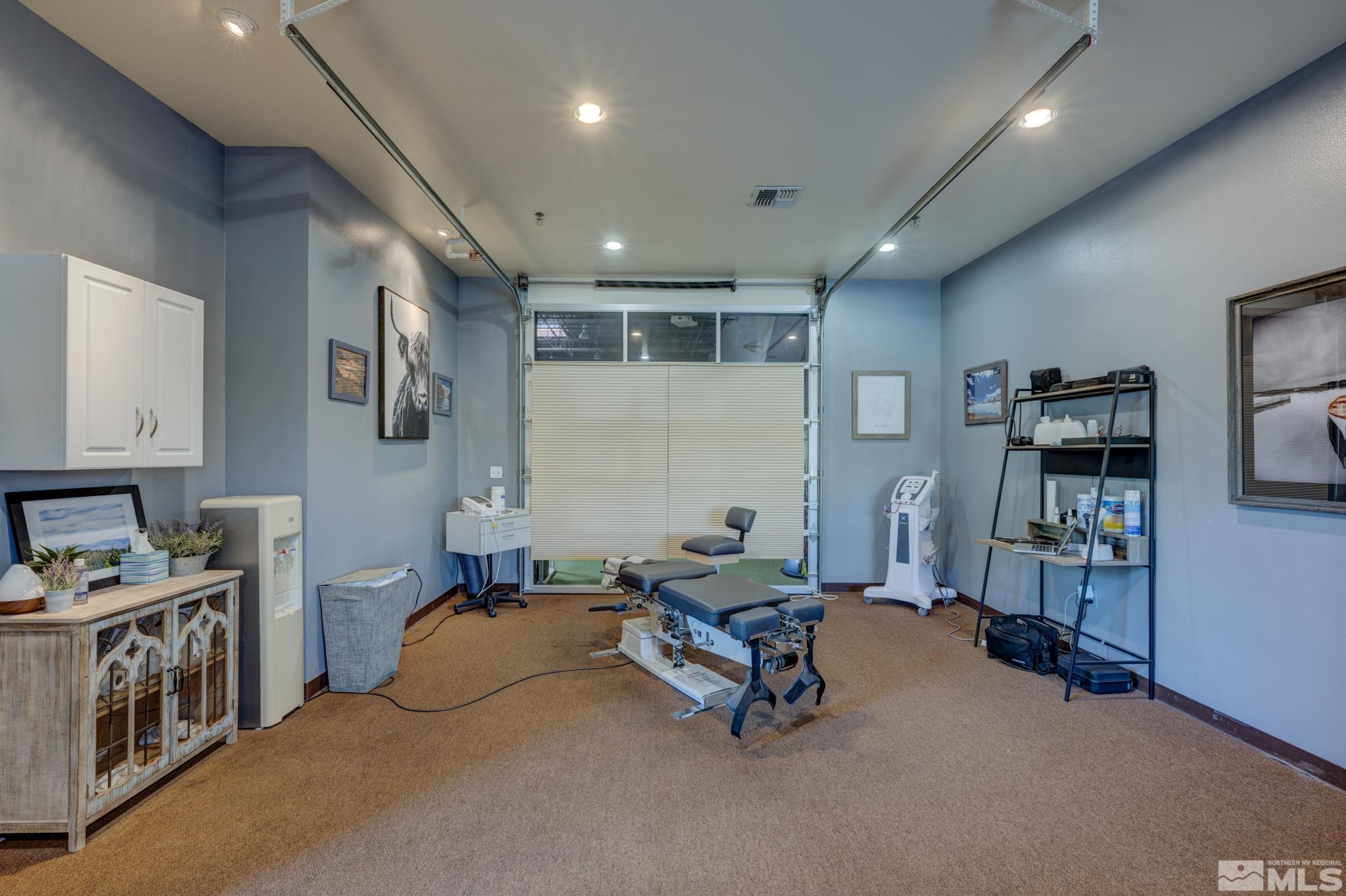 8975 Double Diamond Parkway, Unit 12A Reno, NV 89521 - Photo 1 of 8 a room with furniture and gym equipment