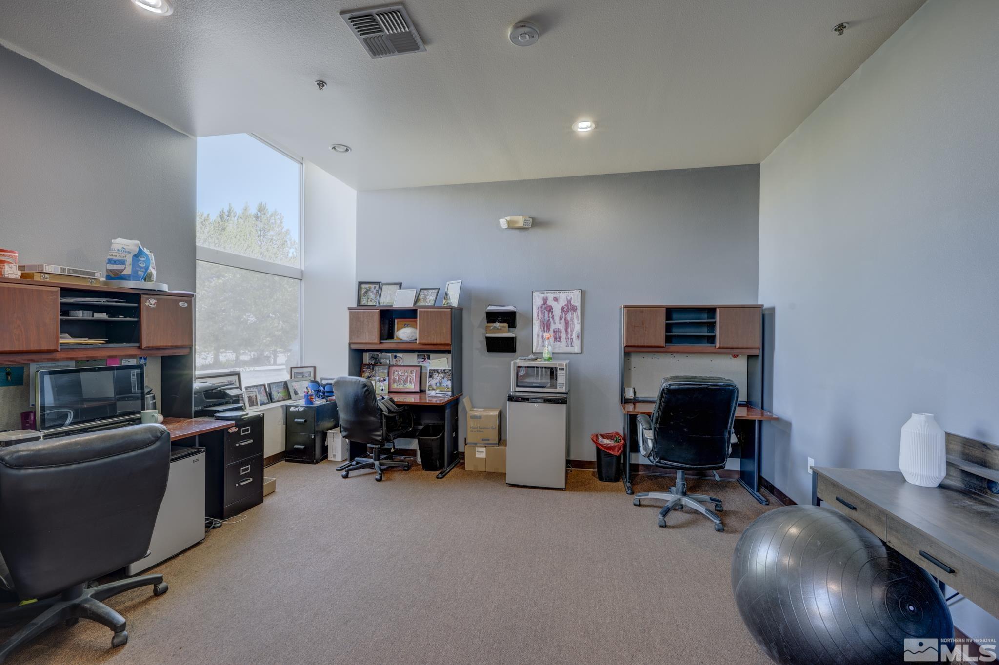8975 Double Diamond Parkway, Unit 12A Reno, NV 89521 - Photo 4 of 8 a view of a livingroom with workspace and a couch