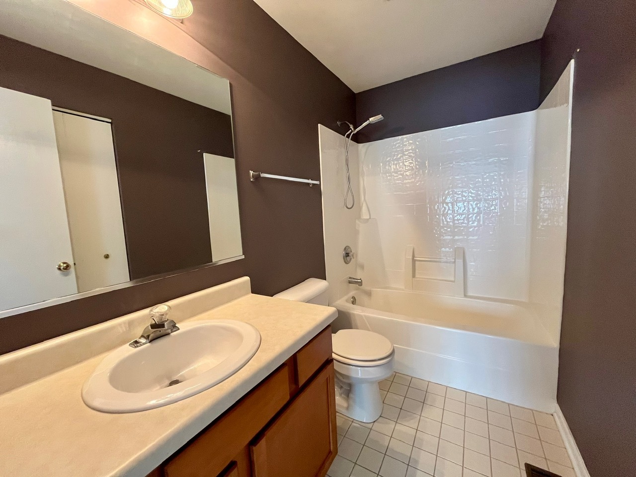 1919 Golden Gate Lane Naperville, IL 60563 - Photo 16 of 18 a bathroom with a sink a toilet and shower