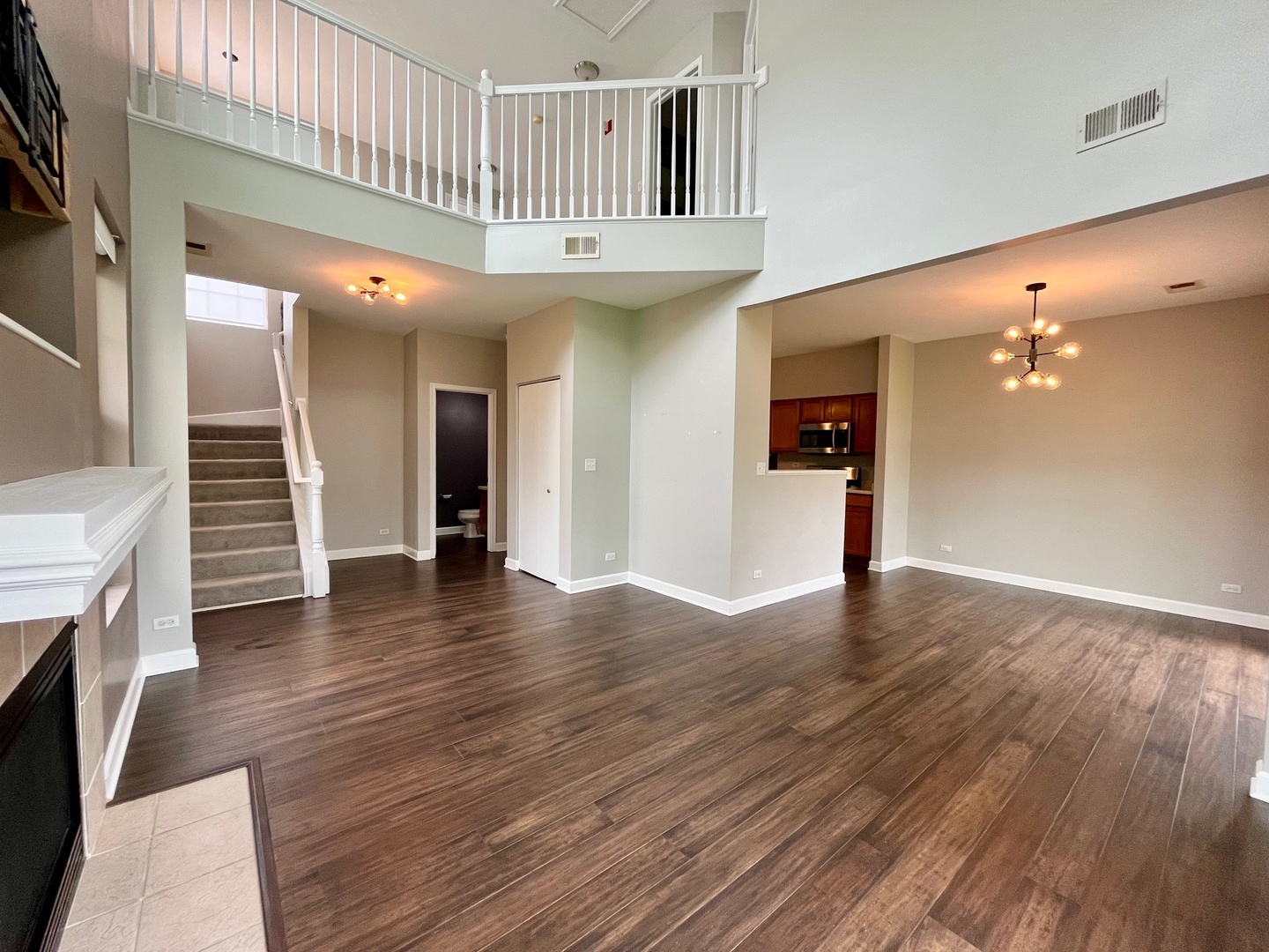 1919 Golden Gate Lane Naperville, IL 60563 - Photo 3 of 18 an entryway with a livingroom with wooden floor and staircase